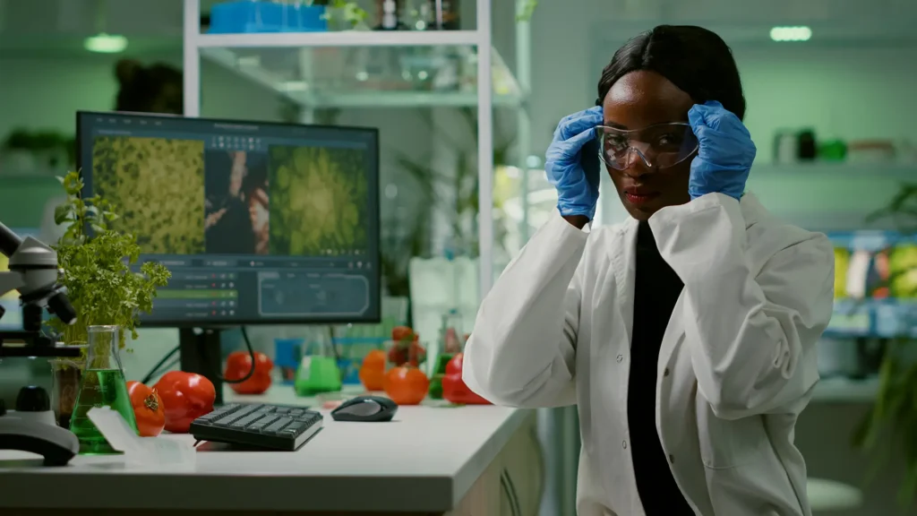 African scientist in laboratory conducting agricultural and public health research using advanced biotechnology at Eagle Precision International.